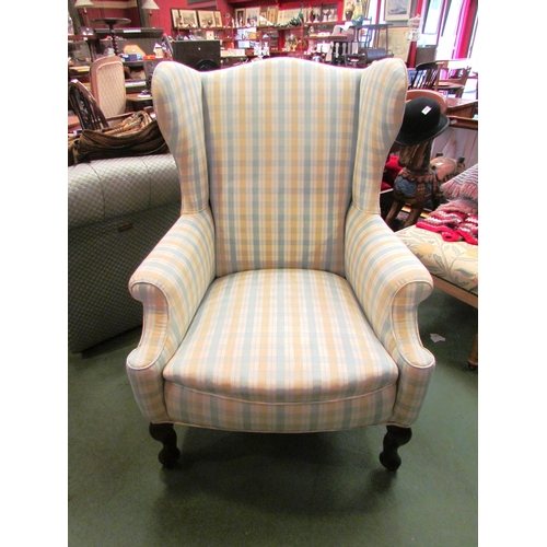 4183 - A Georgian wingback armchair, the scroll arms over cabriole fore feet on castors     (R) £220