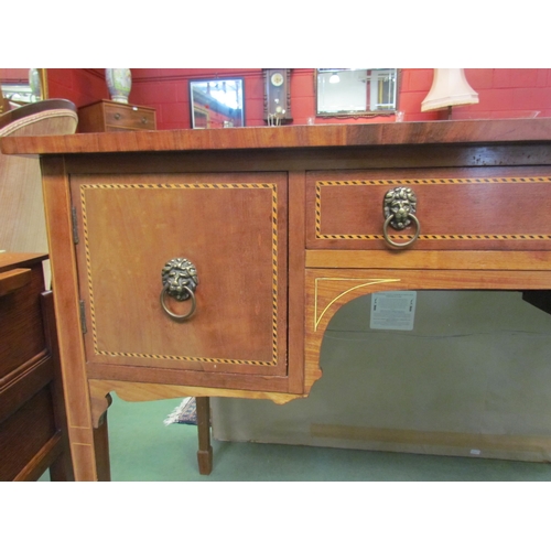 4195 - A reproduction mahogany chequered inlaid three drawer side table with lion mask handles, on tapering... 