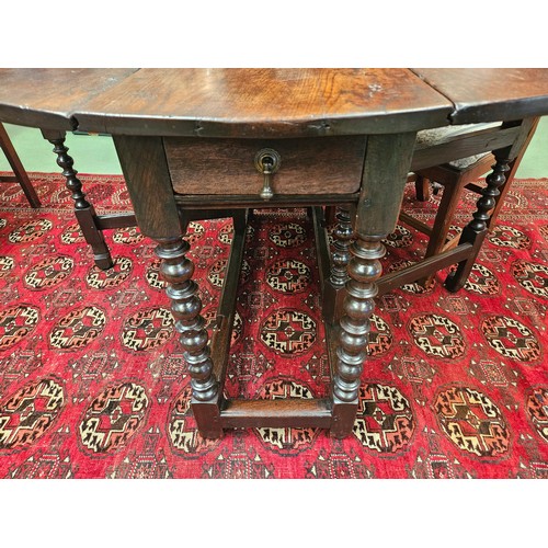 4126 - A Charles II pegged oak gate-leg oval top dining table, the rising leaves over two end drawers and b... 