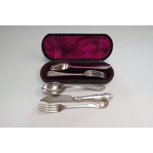 4336 - A Victorian ornate silver Christening spoon and fork (maker's mark RM/EH).  London 1884 and Sheffiel... 