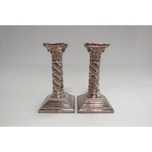 4339 - A pair of silver Corinthian column candlesticks with twisted stem design.  London 1988.  Height appr... 