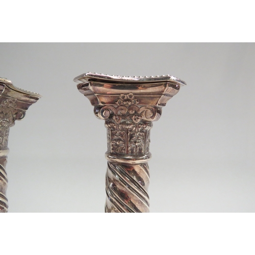 4339 - A pair of silver Corinthian column candlesticks with twisted stem design.  London 1988.  Height appr... 