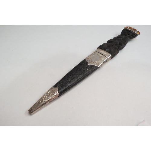 4386 - An Elizabeth II Scottish sgian dubh, with stainless steel blade, carved wood handle set with amber c... 