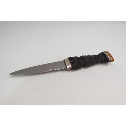 4386 - An Elizabeth II Scottish sgian dubh, with stainless steel blade, carved wood handle set with amber c... 