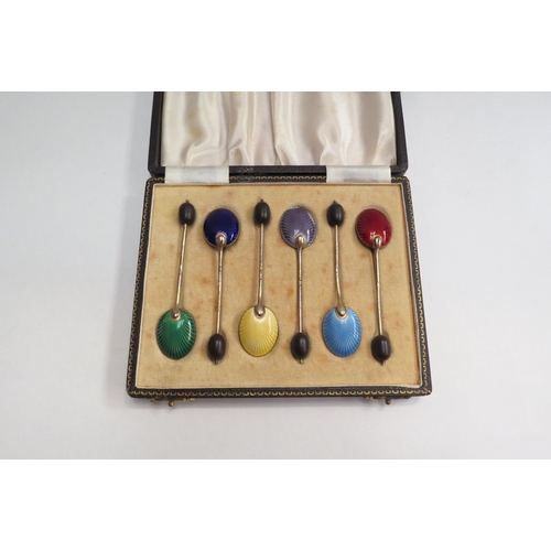 4417 - A cased set of six silver enamel decorated coffee bean spoons, (each spoon enamelled in a different ... 