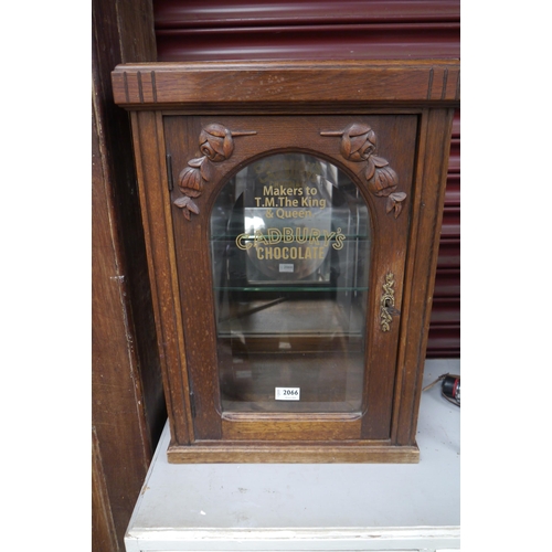 2228 - A glass display cabinet with later applied Cadburys Chocolate lettering   (R) £150