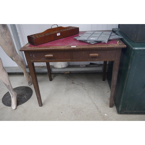 2179 - An oak leatherette topped desk