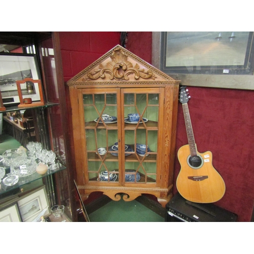 4217 - A George III country house stripped pine corner cabinet with carved decoration, the two astragal gla... 