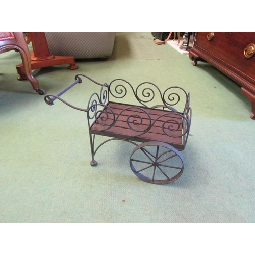 4238 - A wrought metal and slatted wood miniature display trade cart, 25cm tall x 40cm long