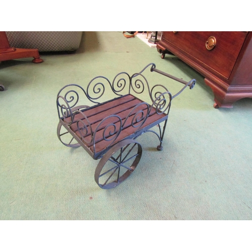 4238 - A wrought metal and slatted wood miniature display trade cart, 25cm tall x 40cm long