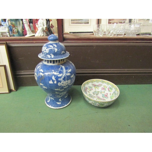 4245 - A 20th Century Oriental bowl with butterfly detail, 26cm diameter, and a blue and white lidded vase,... 