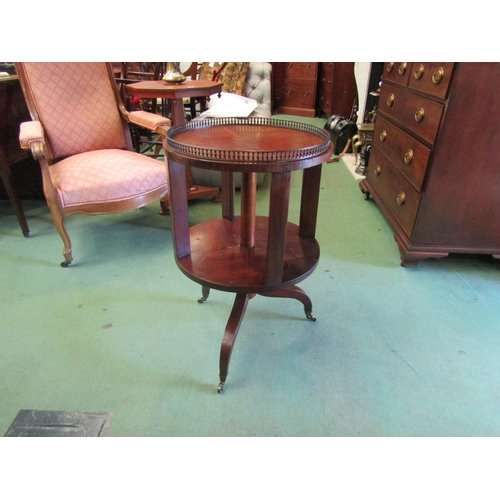 4246 - An Edwardian mahogany revolving circular bookshelf with brass baluster gallery over a chequered inla... 