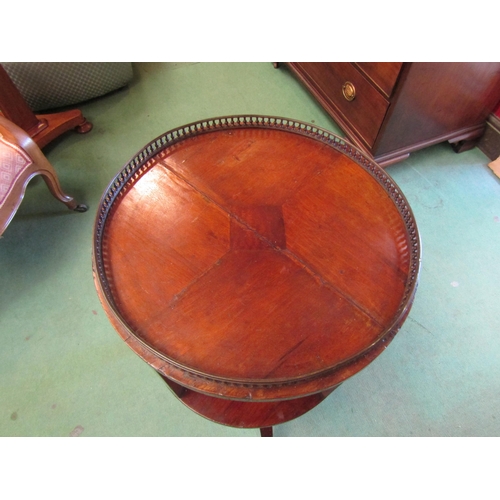 4246 - An Edwardian mahogany revolving circular bookshelf with brass baluster gallery over a chequered inla... 