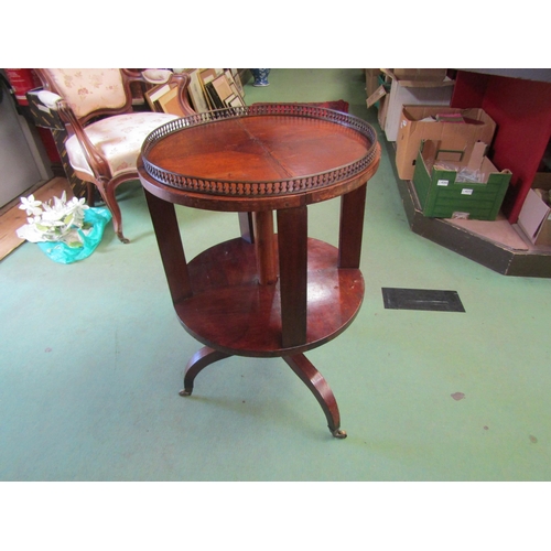 4246 - An Edwardian mahogany revolving circular bookshelf with brass baluster gallery over a chequered inla... 