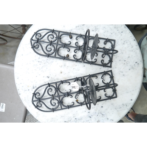 2045 - A pair of wrought iron Gothic wall hanging candle sconces