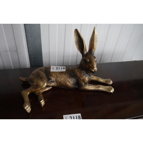 2119 - A resin bronze recumbent shelf sitting hare   (R) £25