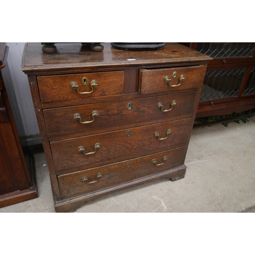 2155 - A Georgian oak two over three chest of drawers