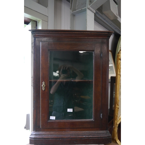 2167 - An oak glazed corner cupboard