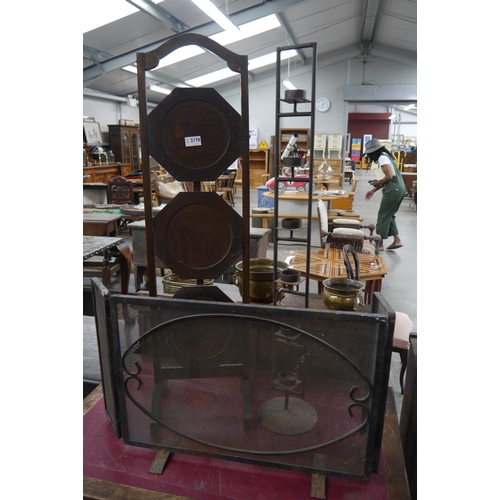 2178 - A 1930's oak cake stand, iron fire guard and candle stick