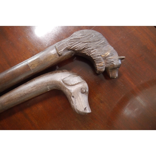 2204 - Two carved wooden walking canes, one dog and one Black Forest style bear