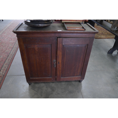 2216 - A Georgian oak two door cabinet