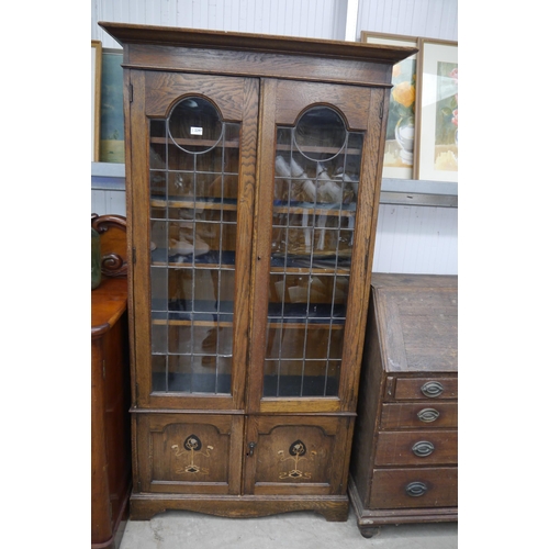 2297 - An oak Edwardian glazed cabinet