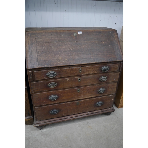 2298 - A Georgian oak four drawer bureau