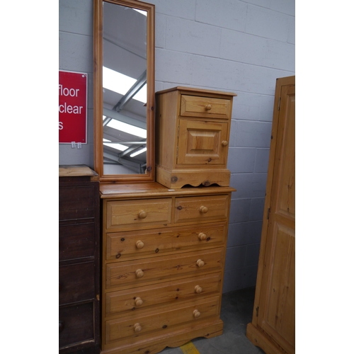 2325 - A pine two over four chest of drawers,  a bedside cabinet and mirror