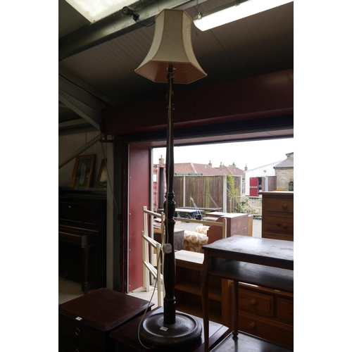 2449 - An oak floor standing lamp