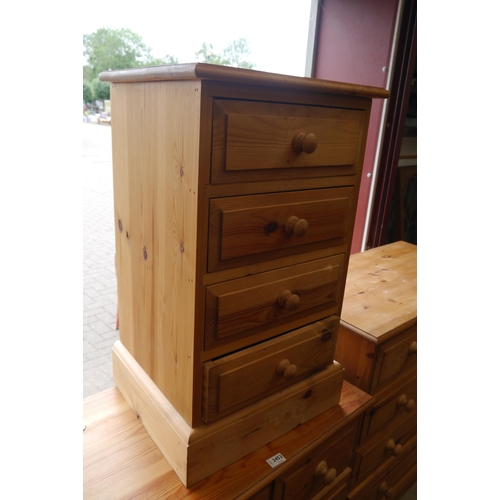 2451 - A pine bedside chest of four drawers