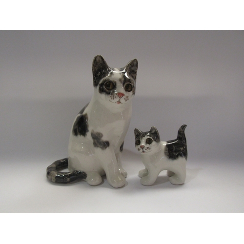 4281 - Two Winstanley cat figurines, black and white, tallest 22cm tall