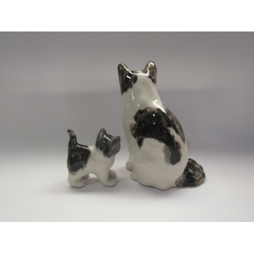 4281 - Two Winstanley cat figurines, black and white, tallest 22cm tall