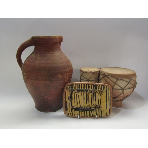 4282 - A terracotta jug 33cm tall, slipware dish and pottery drums