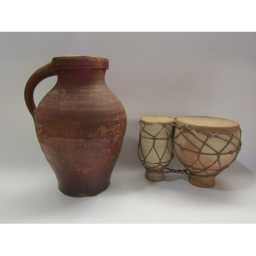 4282 - A terracotta jug 33cm tall, slipware dish and pottery drums