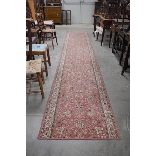 2182 - A red floral runner rug 470cm x 84cm