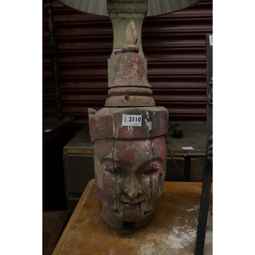 2110 - A carved and painted deity head