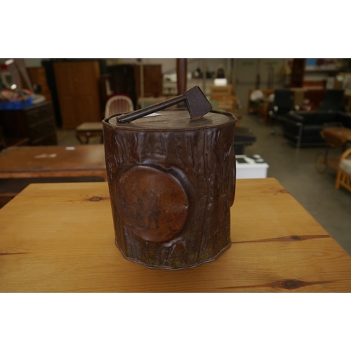 2463 - A biscuit tin with axe to top