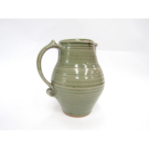 7093 - A St Ives standard ware pottery jug with green glaze, impressed Pottery seal only. 19cm high