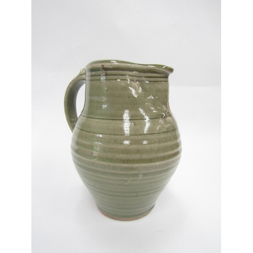 7093 - A St Ives standard ware pottery jug with green glaze, impressed Pottery seal only. 19cm high