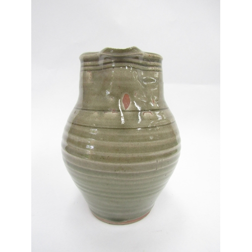 7093 - A St Ives standard ware pottery jug with green glaze, impressed Pottery seal only. 19cm high