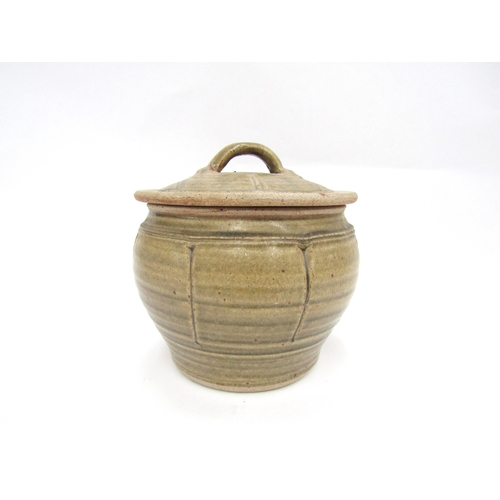 7144 - RICHARD BATTERHAM (1936-2021) A studio pottery lidded pot, greenish glaze and incised line detail. U... 