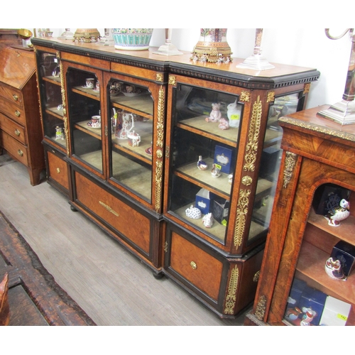 1023 - A 19th Century walnut credenza, the glazed breakfront with ebonised dentil moulding, ormolu mounts, ... 