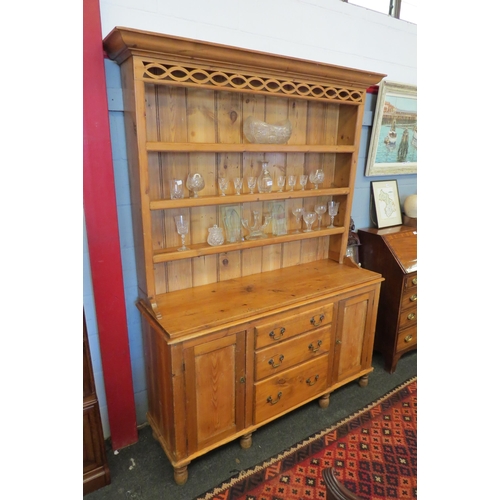 1091 - A Victorian stripped pine dresser base with a shelved plate rack and two keys, 211cm tall x 151cm wi... 