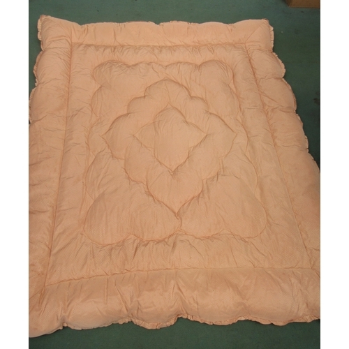 1428 - Two mid-20th Century feather filled peach eiderdowns, one in a sateen finish with an applique stitch... 