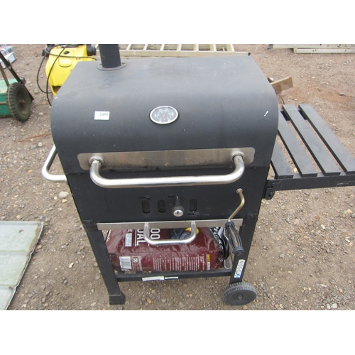 3490 - A BBQ with a bag of charcoal