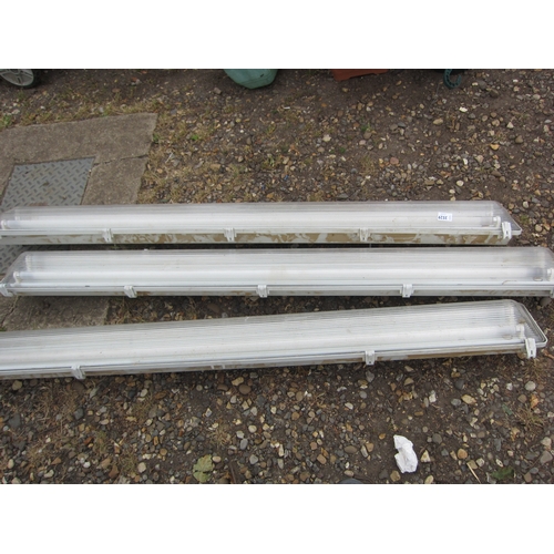 3529 - Three enclosed fluorescent light fittings