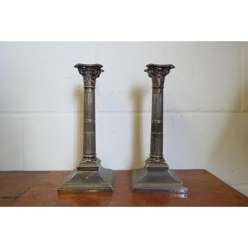 1017 - A pair of Walker & Hall silver plated candlesticks of column form, 28cm tall