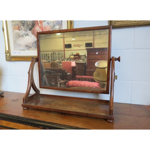 1019 - A mahogany table-top cheval mirror on bun feet