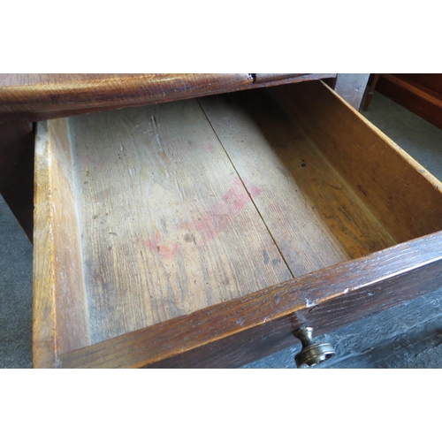 1028 - An 18th Century pegged oak oval plank top gate-leg dining table, the rising leaves over a single end... 