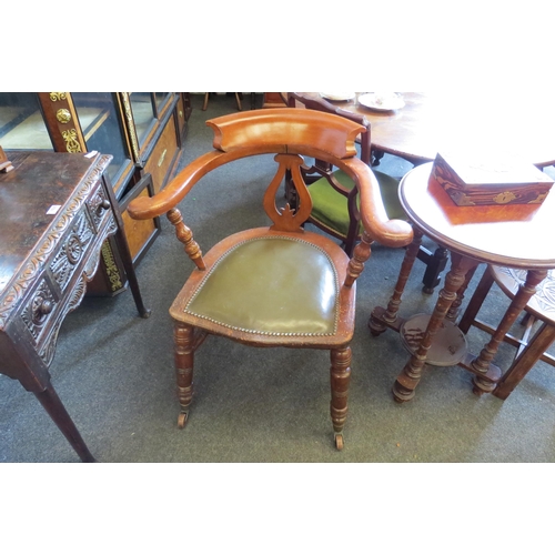 1034 - A circa 1900 walnut captain's chair, studded leather seat, turned supports to castors